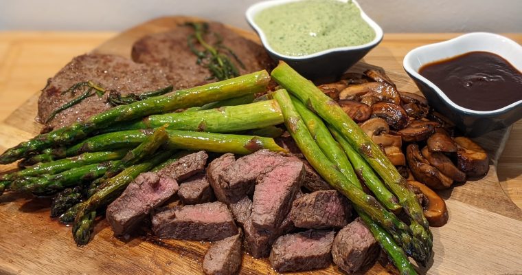 Steak Delight: A Sizzling Platter with Crispy Fried Mushrooms, Asparagus and Homemade Pesto